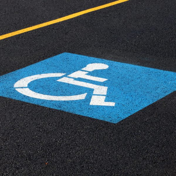 A sign marking a reserved handicapped parking space